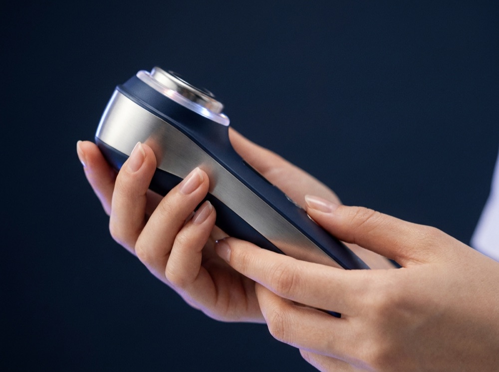 Esthetician hands holding a Korean professional skincare device
