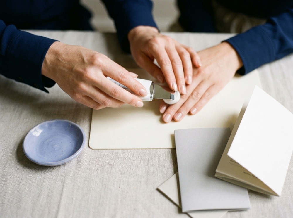 Instructor guiding a trainee through a hands-on skincare technique