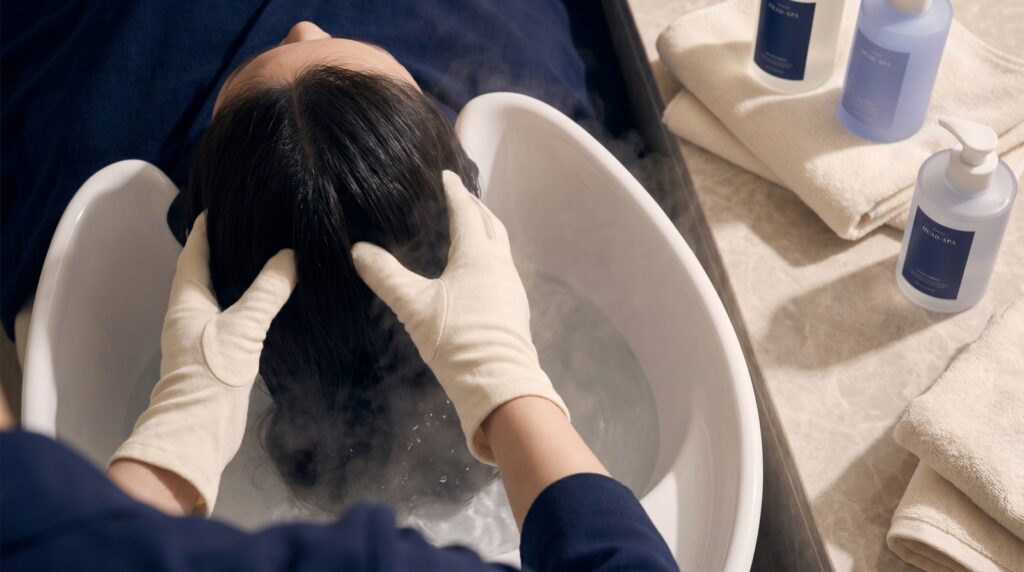 Luxury Korean head spa station with a porcelain water-halo basin and scalp massage