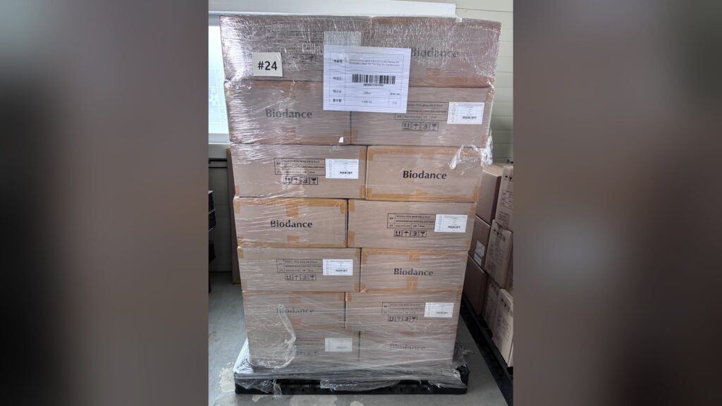 A wrapped pallet of Korean beauty stock in a Seoul warehouse, tagged with its carton count and unit total before loading
